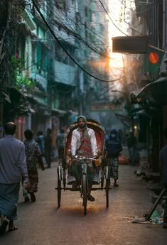 a man riding on the back of a horse drawn carriage