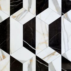 black and white marble tiles are arranged in an irregular pattern, with gold veining on the edges