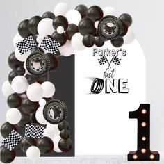 a number one balloon arch with black and white balloons