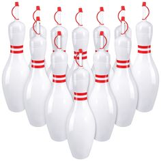 a group of white bowling pins lined up next to each other on a white background