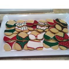 decorated cookies are arranged on a white platter