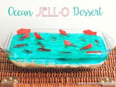 a dessert dish with blue icing and red fish in it