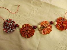 an orange and white flower decoration is hanging on a wall