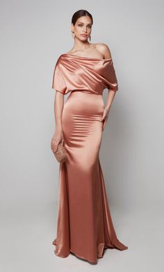 We are obsessing over this goddess gown designed by JDL Alyce Paris. 27560, showcases a unique pleated one-shoulder neckline with drape cap sleeve. The fitted silhouette will define your curves just right and is completed with a lovely, flared skirt with sweep train that will sway with every step that you take! Dont want to miss out on this hot gown? Give us a call at Terry Costa for available sizes and ship dates. This dress is a final sale. No Returns or Exchanges. Tube Gown, Plastic Dress, Mango Dress, Alyce Paris, Black Tie Event, Gala Dresses, Bouquet Wedding, Groom Dress, Bride Dresses