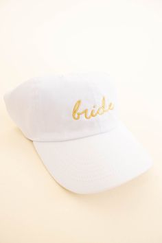 This classic hat is perfect for a bride-to-be! It is adjustable for maximum comfort and features beautiful gold embroidery. It is sure to add the perfect touch to your wedding weekend look! Gold Adjustable Cap, Classic Gold Hat With Adjustable Fit, Classic Gold Adjustable Hat, Classic Adjustable Gold Hat, Adjustable Gold Cap, White Curved Brim Baseball Cap For Wedding, Adjustable Curved Brim Hat For Mother Of The Bride, Bride Hat, Classic Hats