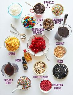 the ingredients for an ice cream sundae laid out on a white surface with their names