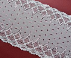 an image of white lace on red background