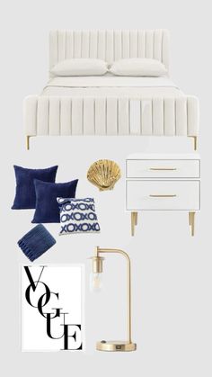 a white bedroom with blue and gold accessories on the bed, nightstands, lamps, and pillows