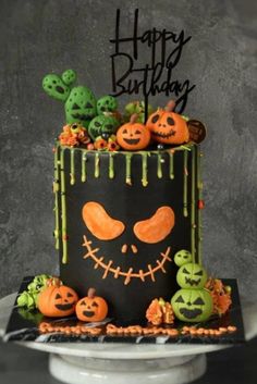 a halloween cake with pumpkins and jack - o'- lantern decorations on it