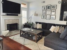 a living room filled with furniture and a flat screen tv mounted on the wall above a fireplace