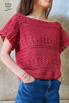 a woman is wearing a red crochet top