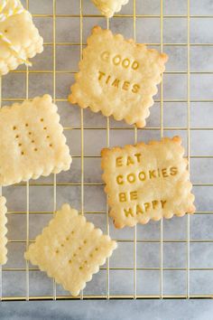 cookies that say good times and eat cookies be happy on a cooling rack with cookie cutters