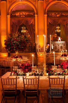 a dining table with candles and flowers on it