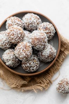 a bowl filled with coconut balls on top of a table