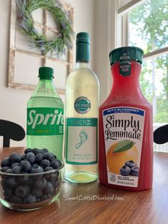 the ingredients to make blueberry lemonade are displayed on a table