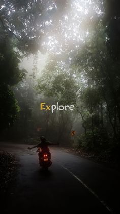 a person riding a motorcycle down a road with the words explore on it's side