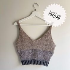 a knitted crop top hanging on a hanger with the knitting pattern below it