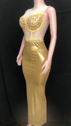 Introducing our stunning handmade Golden Graduation Gown, a masterpiece of elegance and glamour. Crafted with meticulous attention to detail, this gown is designed to make you shine on your special day. Made from a luxurious blend of spandex and polyester, this gown offers a perfect balance of comfort and style. The fabric drapes beautifully, enhancing your silhouette and allowing you to move with grace. Breathable and sustainable, this gown ensures you stay comfortable throughout your graduation ceremony. The fabric allows for airflow, keeping you cool and confident as you receive your well-deserved accolades. The empire waistline adds a touch of regal charm, creating a flattering and elongating effect. It accentuates your figure and adds an element of sophistication to your overall look. Stretch Evening Dress For Gala During Party Season, Fitted Floor-length Gown For Gala, Glamorous Satin Ball Gown For Parties, Gold Backless Evening Dress, Fitted Gold Mermaid Dress With Sweep Train, Gold Mermaid Dress With Sweep Train, Gold Backless Maxi Dress For Prom, Fitted Backless Gown For Gala, Gold Mermaid Dress With Sweep Train Floor-length