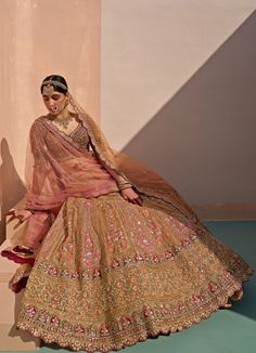 Features a mustard rust hued organza double dupatta lehenga set embroidered with traditional zardozi technique using silken threads, dabka, cutdana and sequins highlighted with multi coloured organza appliques. Composition : Lehenga, Blouse and Dupatta- Organza Care: Dry Clean Only and Vacuum Storage This product can be customised for sleeves, length of blouse and neckline Delivery : 6-8 weeks as the product is hand crafted. Check Size Guide or choose MySize for free customisation (All Sizes above XL can be made at 15% additional cost) For more information and sizes please contact fabiliciousfashion@gmail.com or visit our Copenhagen studio. About the Designer : Angad Singh's journey in the world of fashion started with at an early age as he grew up in a family business that was immersed in Traditional Gold Organza Lehenga, Brown Anarkali Dupatta For Festive Occasions, Festive Anarkali Brown Dupatta, Traditional Gold Organza Choli, Brown Chanderi Dupatta With Resham Embroidery, Festive Brown Anarkali Dupatta, Anarkali Style Brown Dupatta For Festive Occasions, Brown Traditional Wear With Dupatta, Gold Organza Lehenga With Cutdana