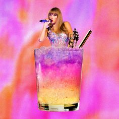 a woman in a purple and yellow dress holding a microphone while sitting in a tall glass filled with liquid