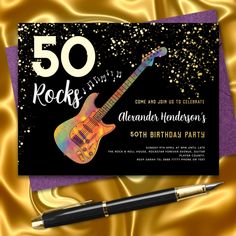 a 50th birthday party card with an electric guitar on it and a pen next to it