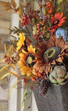 a vase filled with lots of different types of flowers