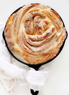 a cast iron skillet filled with cinnamon rolls