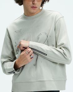 The Distressed Zipper Sweatshirt is a perfect fusion of avant-garde style and meticulous craftsmanship, offering a bold statement piece for your wardrobe. This slightly oversized sweatshirt features a striking graphic print on the front, adding visual interest and a contemporary edge. The zipper accents on the cuffs bring a unique, rebellious touch to the design. Crafted from premium 100% cotton, this sweatshirt combines comfort with standout style, making it an essential for any modern look. Gr Crew Neck Sweatshirt With Zipper For Streetwear, Relaxed Fit Long Sleeve Sweatshirt With Zipper, Streetwear Long Sleeve Sweatshirt With Zipper, Long Sleeve Sweatshirt With Zipper For Streetwear, Urban Sweatshirt With Zipper Closure, Urban Sweatshirt With Zipper Closure And Long Sleeves, Urban Style Sweatshirt With Zipper Closure, Urban Long Sleeve Sweatshirt With Zipper Closure, Urban Style Long Sleeve Sweatshirt With Zipper