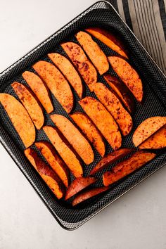 cooked sweet potato wedges on a baking tray ready to be baked in the oven