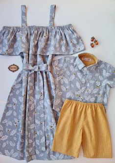 two children's clothing items are laid out on a table