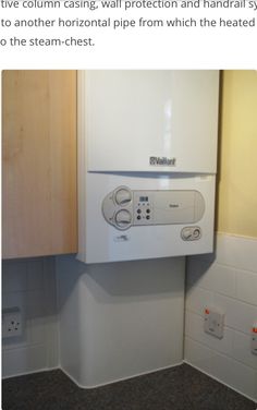 a white wall mounted oven sitting on top of a kitchen counter