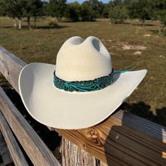 Genuine leather hatband in teal blue color. This hatband is adjustable with leather ties. Turquoise Hat Band, Tooled Leather Hat Band, Blue Short Brim Hat For Ranch, Adjustable Leather Hat Bands For Kentucky Derby, Adjustable Hat Bands For Kentucky Derby, Western Leather Hat Bands For Kentucky Derby, Kentucky Derby Adjustable Leather Hat Bands, Adjustable Blue Hat For Country Events, Adjustable Fedora With Short Brim For Riding