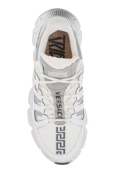 Trigreca sneakers by Versace made of canvas with degradé and padded leather inserts at sides. Laminated and top-stitched leather insert on toe, Greca print detail on toe, lace loops with lettering logo, Trigreca print on tongue and heel, Milan coordinates print. Fabric lining, cork logo insole, suede tongue and spoiler, silver-tone rubber sole with built-in Medusa patch on bottom and three-dimensional Greca pattern, which offers high absorption due to the "Greca cushioning system". Versace Brand, Lettering Logo, Marine Serre, Versace Men, Stitching Leather, Gianni Versace, Roberto Cavalli, Letter Logo, Print Fabric