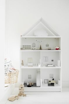 a white doll house with all the furniture and accessories in it's display case