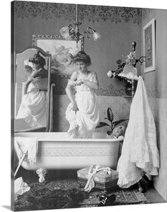 an old black and white photo of two women in a bathtub