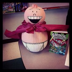 a pumpkin sitting on top of a table next to a box of gummy bears