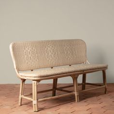 a wooden bench sitting on top of a tiled floor