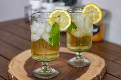 two glasses filled with ice and lemon slices