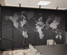 a black and white world map on a wall