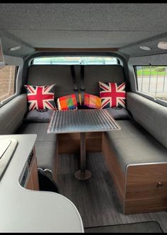 the inside of a camper with a table and couch