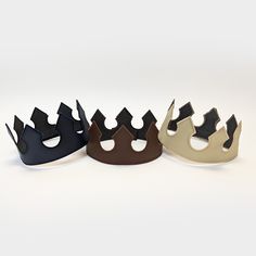 These medieval crowns are great for any royal themed event or anyone trying to finish a king, queen, prince, or princess costume. Each crown is made from vinyl leather with embroidered edges. Crowns have adjustable hook/loop fastening in the back to fit a range of sizes (one size fits most). Choose from 15 color options.Plain Crowns - Solid color crowns with matching stitching along the edges for a clean finishCrown with Jewels - Choose your crown color and then we will provide an additional lay Adjustable Costume Crown, Adjustable Round Crown For Costume Party, Adjustable Tall Crown For Costume, Adjustable Structured Costume Crown, Adjustable Structured Crown For Costume, Adjustable Tall Crown, Medieval Crowns, Crown With Jewels, Medieval King