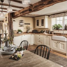 a wooden table sitting inside of a kitchen