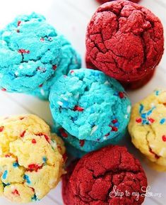 colorful cookies are arranged on a plate with sprinkles