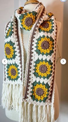 a crocheted scarf with sunflowers on it, and two different colors