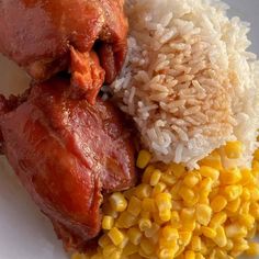 the meal is prepared and ready to be eaten on the plate with rice, corn, and meat