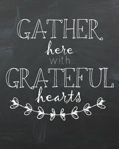 the words gather here with grateful hearts written on a chalkboard in white lettering, against a black background