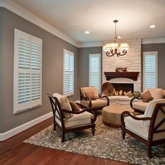 a living room filled with furniture and a fire place in the middle of a room