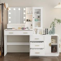 a white vanity with lighted lights and drawers