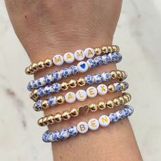 🔹 Design the custom name bracelet that you have always wanted! These beaded word bracelets stacking can be personalized so you can get exactly what you want. 🔹They are made with 6mm blue flower porcelain/ceramic beads, 6mm 18k gold plated beads, 7mm white acrylic beads with gold letters and then strung together with a strong double-strung elastic cord. 🔹Please add each bracelet style separately to your cart. They will be sent to you as a stack. If you want all six bracelets, please choose the option for all six bracelets, otherwise you will receive the single styles that you purchased. 🔹Each custom beaded bracelet stack is packed in a gift box wrapped in organza ribbon and a handwritten message can also be included. It makes the perfect gift for yourself or for Christmas, a baby shower Personalized Blue Charm Bracelet For Birthday, Customizable Name Bracelet With Round Beads As Personalized Gift, Personalized Beaded Bracelets As Gifts, Customizable Name Bracelet With Round Beads For Personalized Gift, Personalized Name Beaded Bracelets For Mother's Day, Personalized Mother's Day Beaded Name Bracelets, Customizable Bracelets With Round Beads For Personalized Gift, Customizable Charm Bracelet For Birthday, Blue Bracelets For Mother's Day Personalized Gift