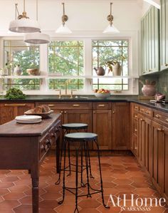 a kitchen with two stools in front of the counter